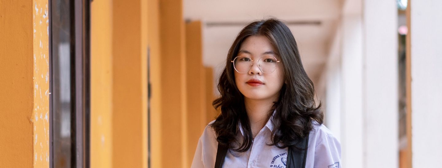 Female standing in hallway.