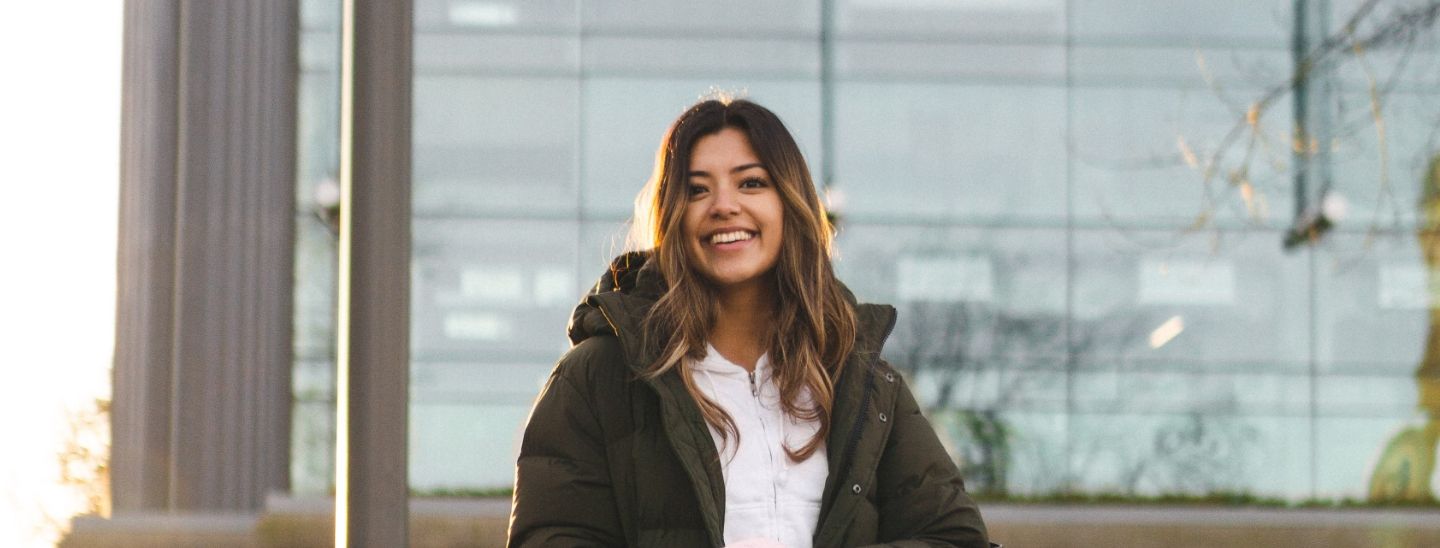 Student standing outside smiling